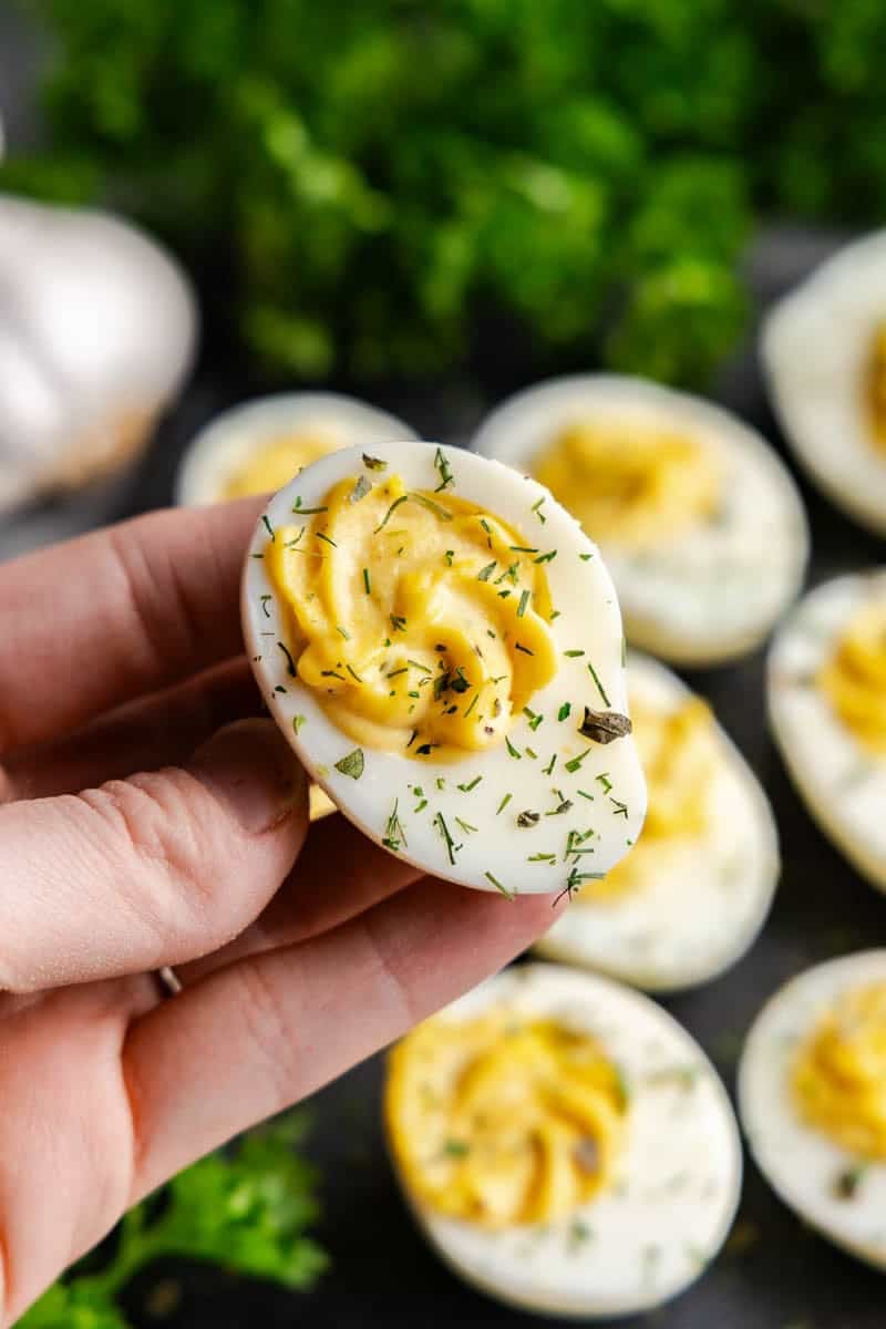 Hand holding a Ranch Deviled Egg.