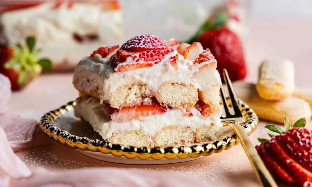 Slice of Strawberries & Cream Tiramisu on a plate showing off the layers.