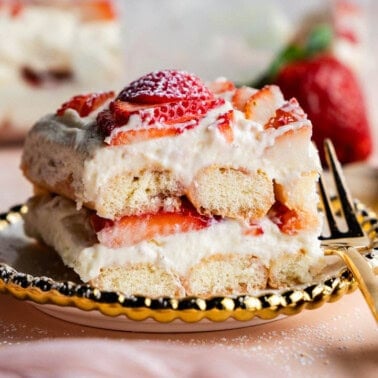 Slice of Strawberries & Cream Tiramisu on a plate showing off the layers.