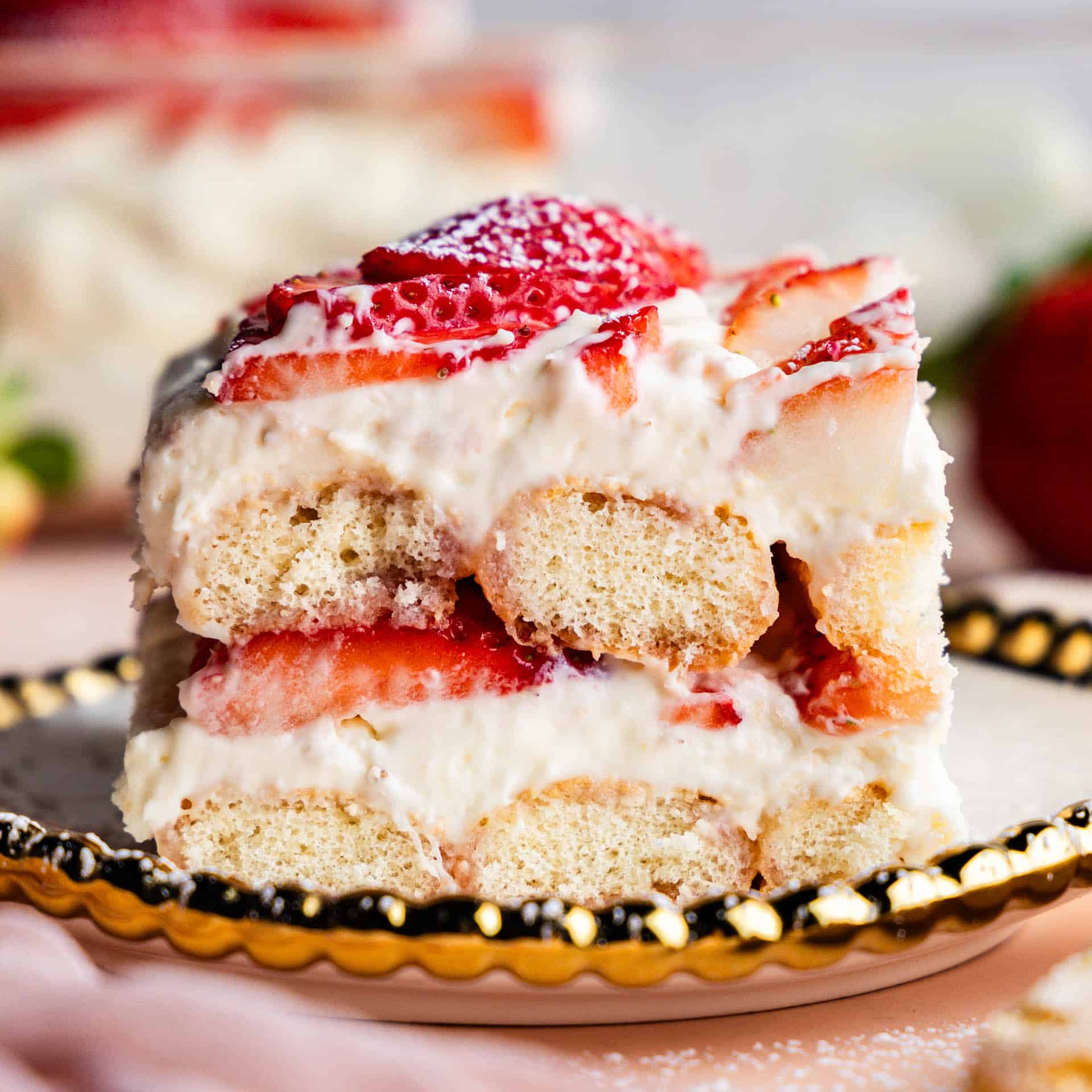 Slice of Strawberries & Cream Tiramisu on a plate showing off the layers.