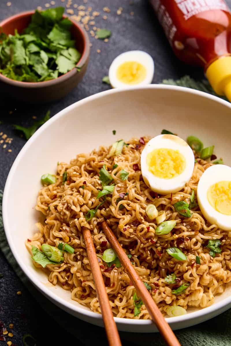 15 Minute Sriracha Ramen Noodles with soft boiled eggs and chopsticks.