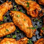 Closeup of chicken wings in air fryer.