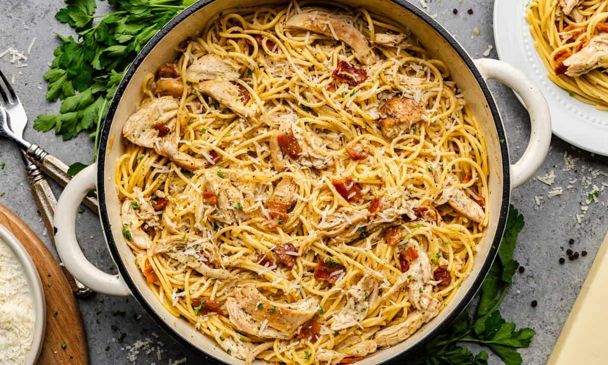 Overhead shot of chicken carbonara in cast iron pot.