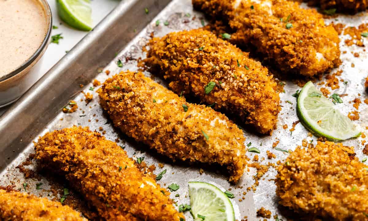 Closeup of Chili-Lime Baked Chicken Tenders on a sheet pan.