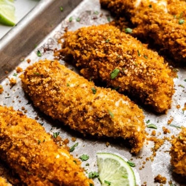 Closeup of Chili-Lime Baked Chicken Tenders on a sheet pan.
