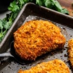Closeup of Breaded Pork Chops on a sheet pan.