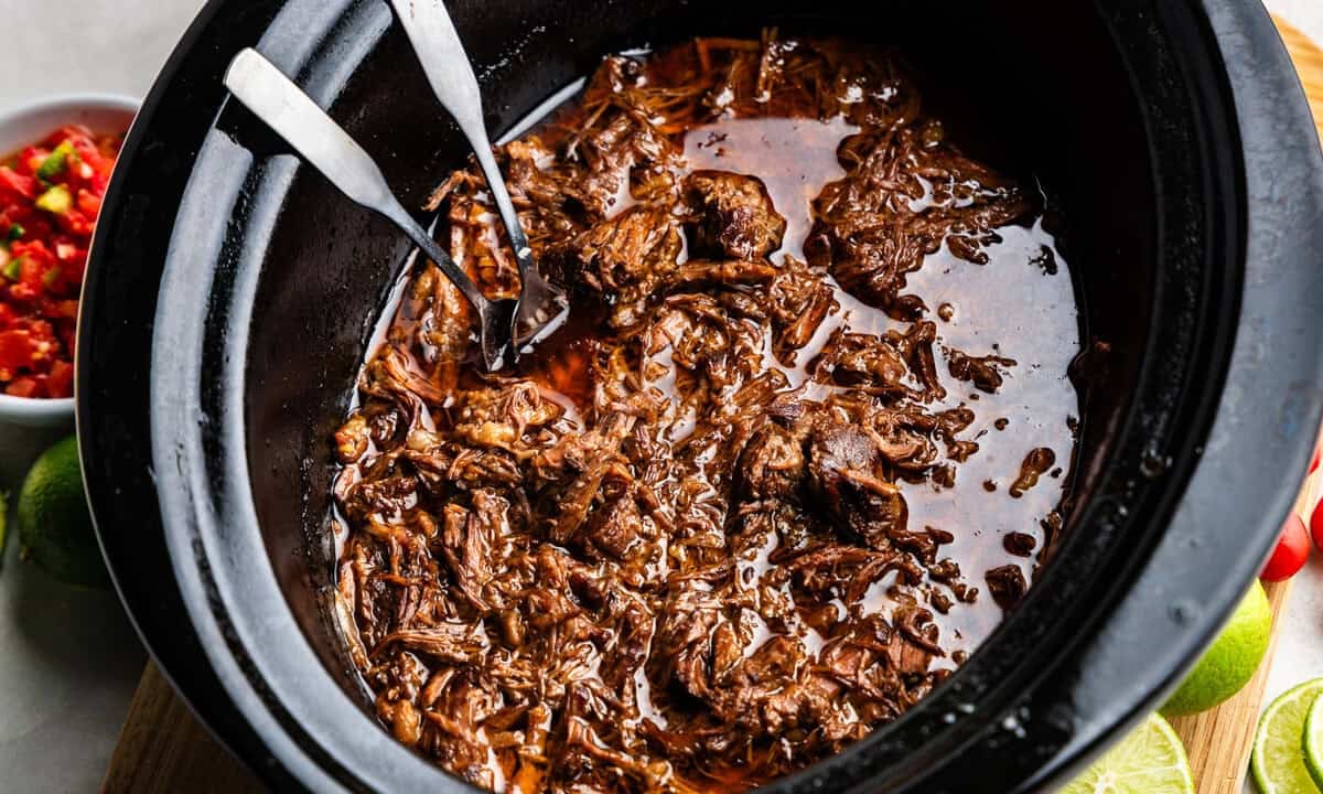 Closeup of Chili-Lime Mexican Shredded Beef in a slow cooker.