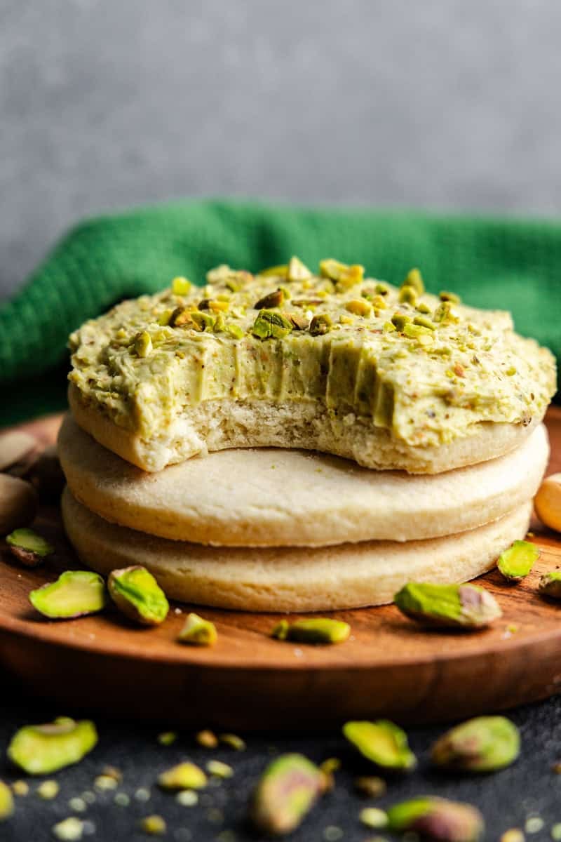 Closeup of Pistachio Buttercream Frosting on a cookie with a bite taken out of it.