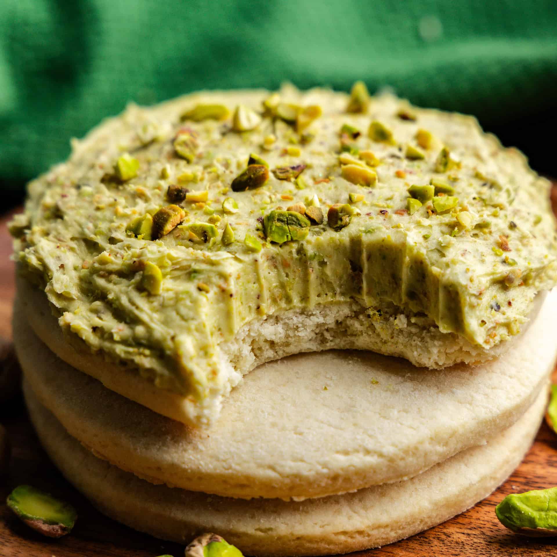 Closeup of Pistachio Buttercream Frosting on a cookie with a bite taken out of it.