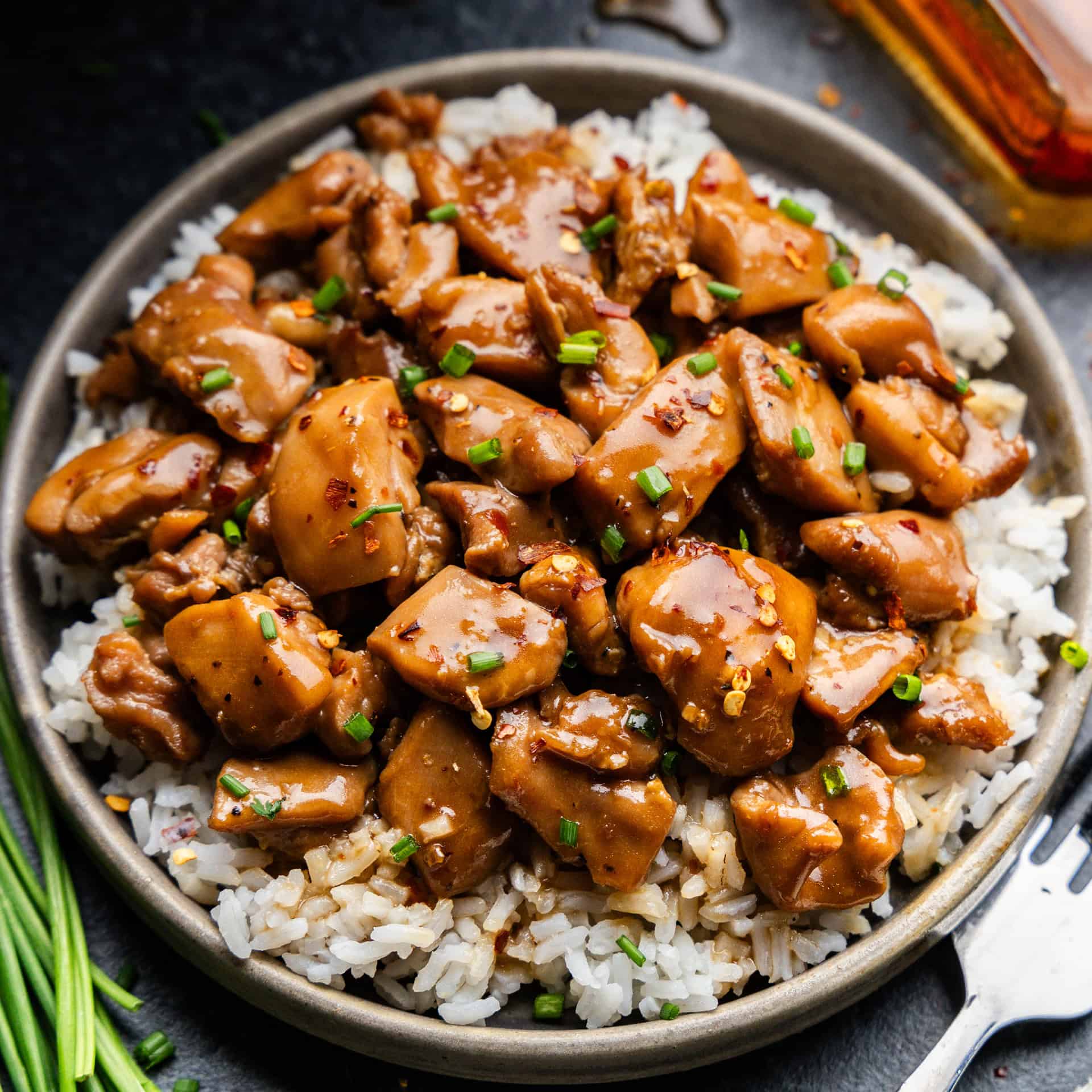 Closeup shot of Bourbon chicken on a plate of rice.