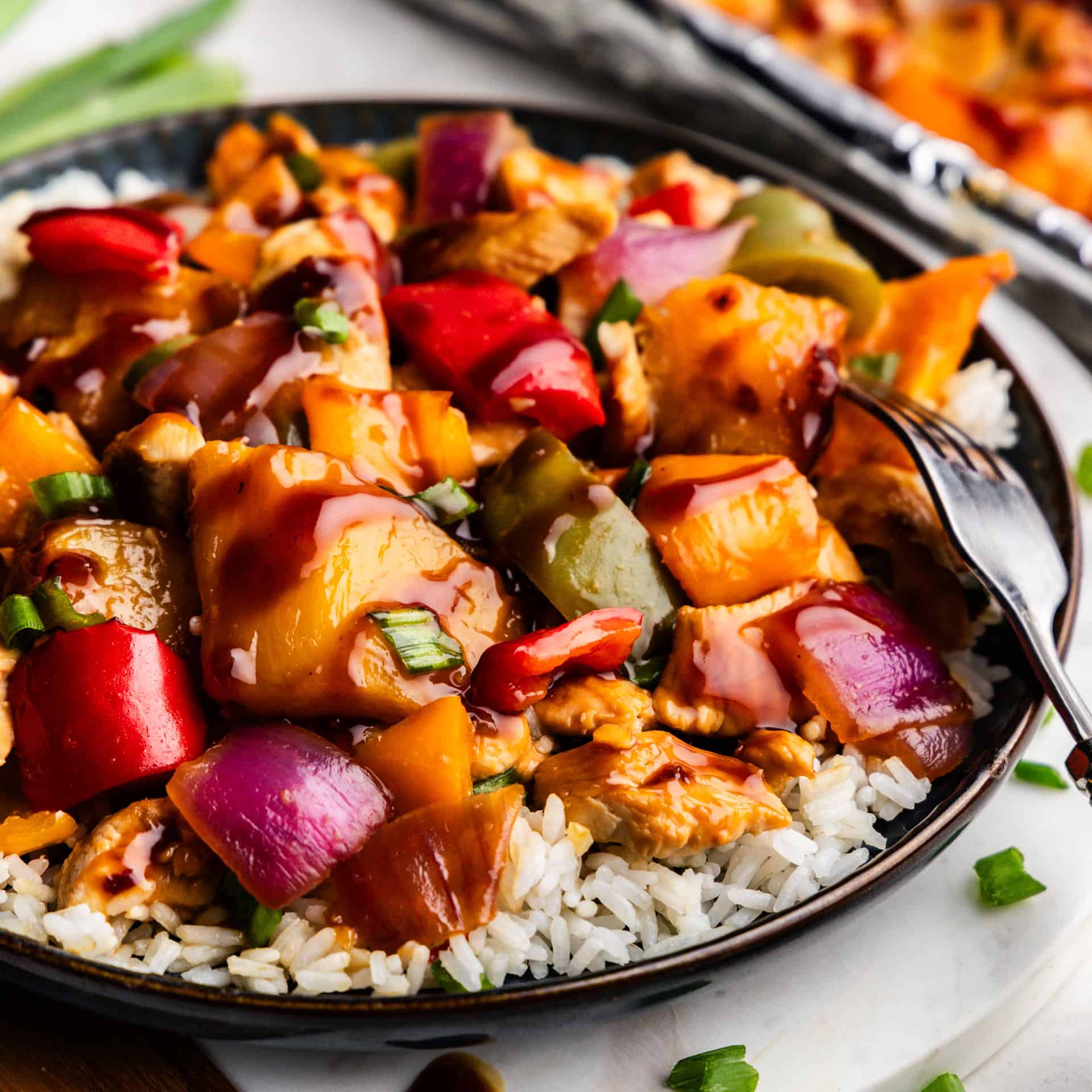 Closeup of Hawaiian Chicken & Veggies on a plate of rice.