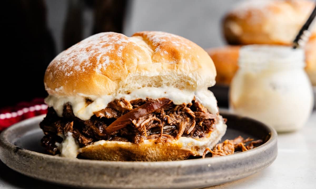 Closeup of a Shredded Beef and Horseradish Sandwich on a plate.