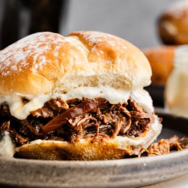 Closeup of a Shredded Beef and Horseradish Sandwich on a plate.