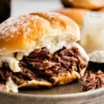 Closeup of a Shredded Beef and Horseradish Sandwich on a plate.