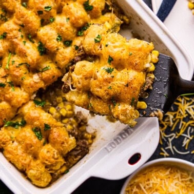 A piece of Tasty Tater Tot Casserole being dished out of pan.