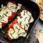 Overhead closeup of chicken parmesan in an air fryer.