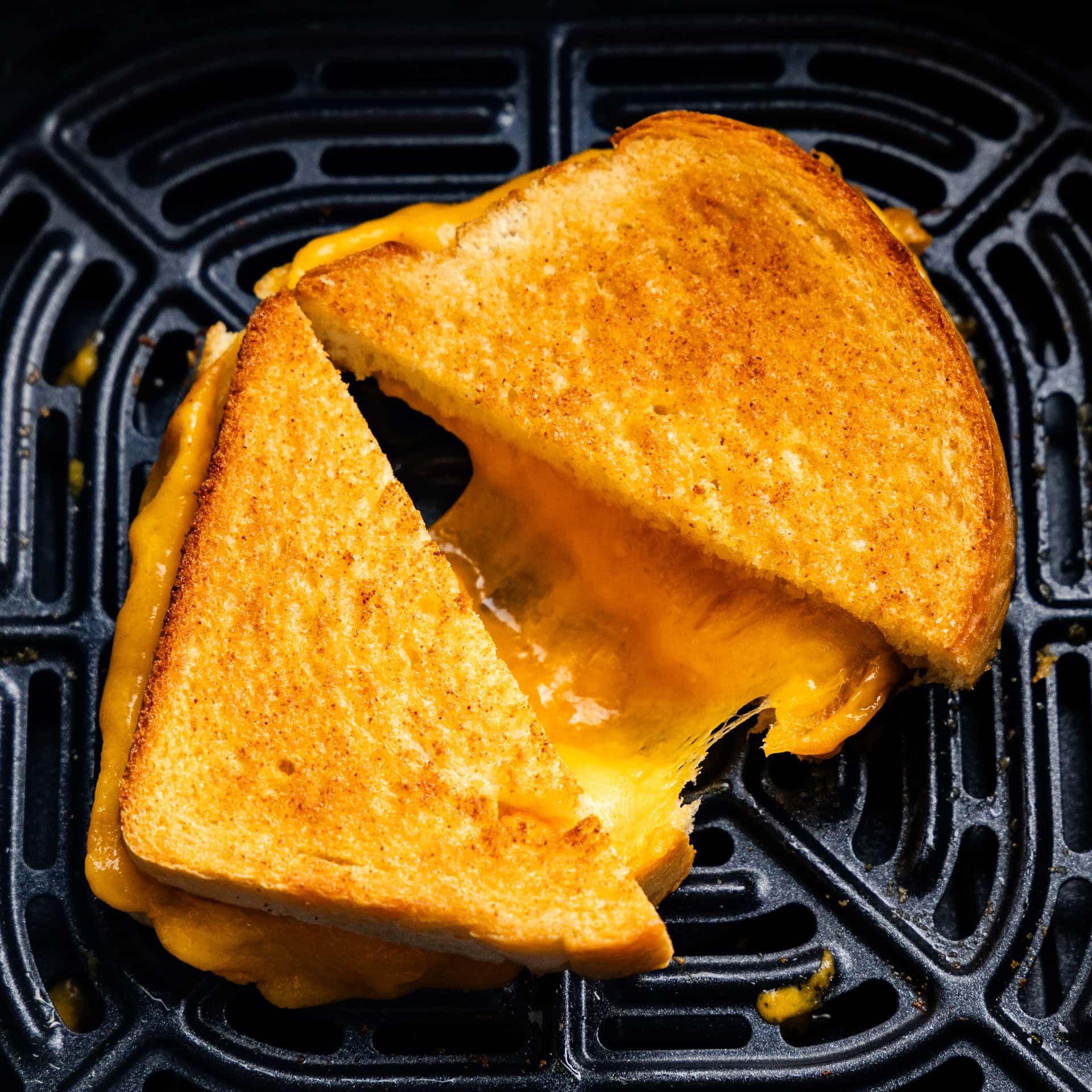 Closeup of Grilled cheese split in half in the air fryer.