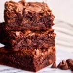 Three decadent brownies stacked on top of each other from the Best Brownie Recipe Ever.