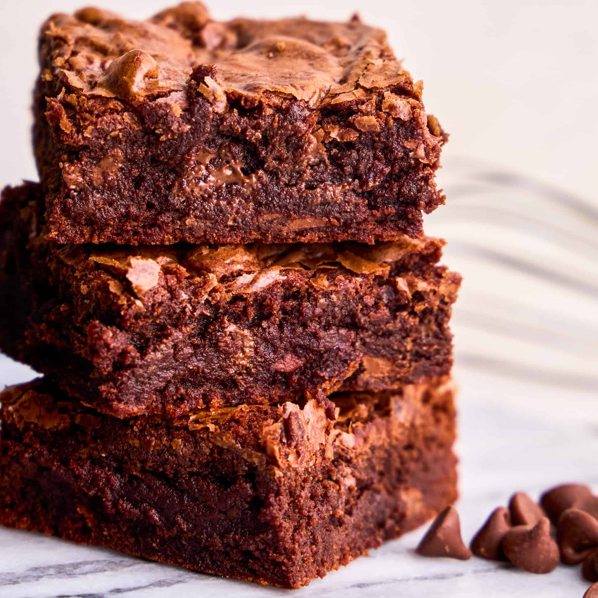 Three decadent brownies stacked on top of each other from the Best Brownie Recipe Ever.