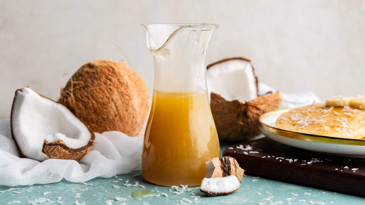 Coconut syrup in a pitcher.