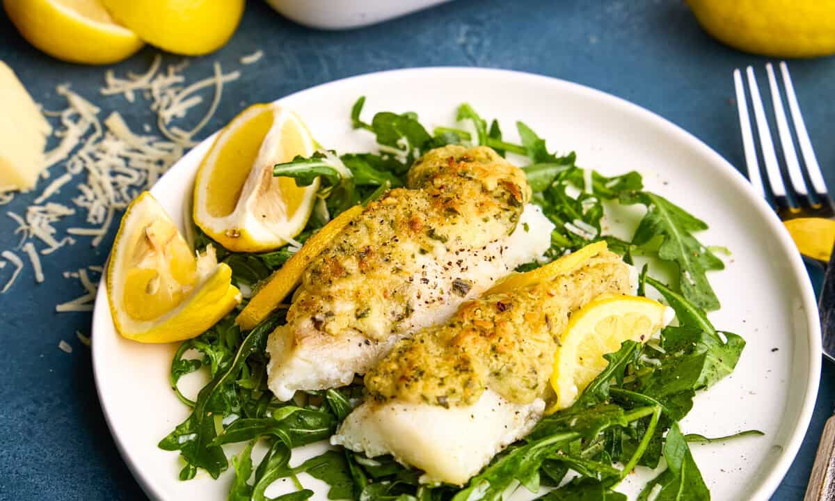 Easy Lemon Baked Cod Fish on a plate with lemons.