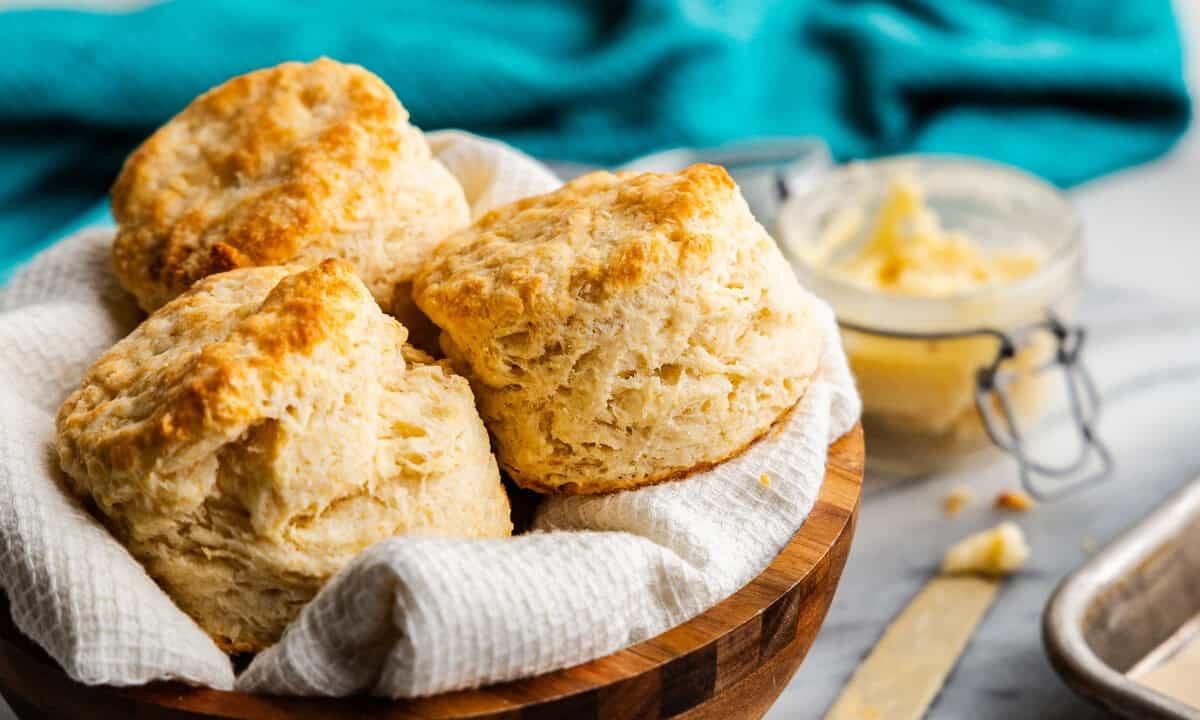 Flaky biscuits piled in a bowl.
