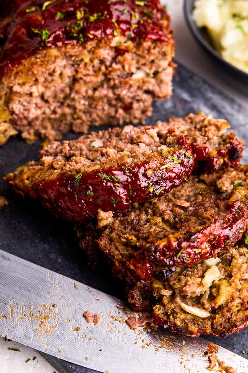 Momma's Meatloaf sliced on a cutting board.