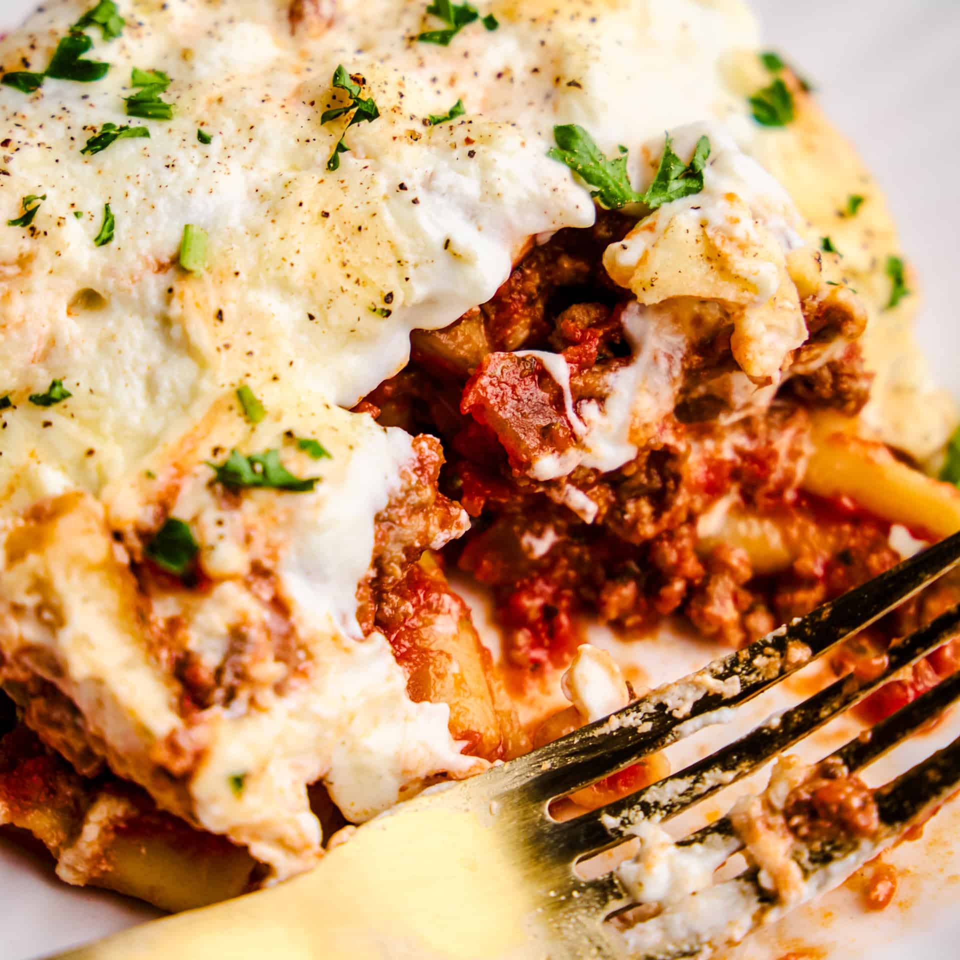 A closeup image of a Slice of the Best Baked Ziti Ever with a fork.