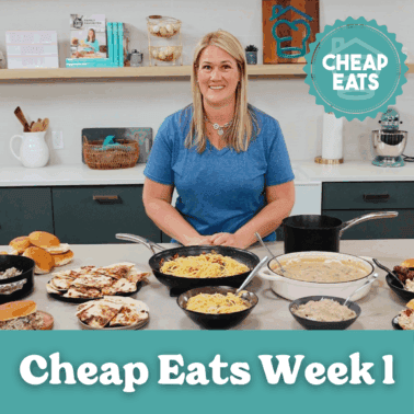 A photo of Chef Cayt in The Stay At Home Chef Kitchen with the meals from Week 1 of the Cheap Eats Meal plan on display on the kitchen counter.