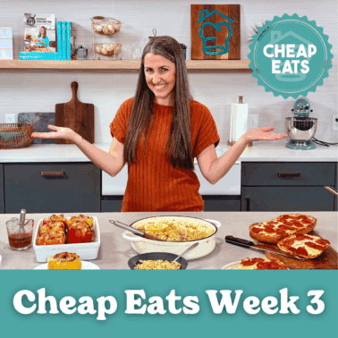 A photo of Rachel in The Stay At Home Chef Kitchen with the meals from Week 3 of the Cheap Eats Meal plan on display on the kitchen counter.