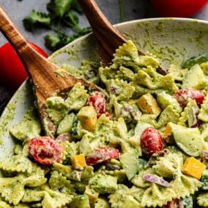 Closeup of cilantro ranch pasta salad being grabbed tongs.