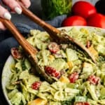 Closeup of cilantro ranch pasta salad being grabbed tongs.