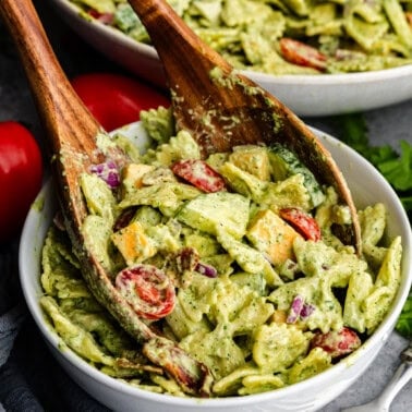 Closeup of cilantro ranch pasta salad being grabbed tongs.