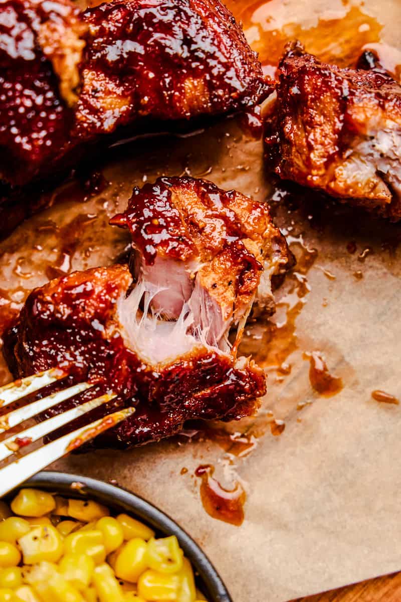 A Country Style Pork Rib being pulled apart with a fork.