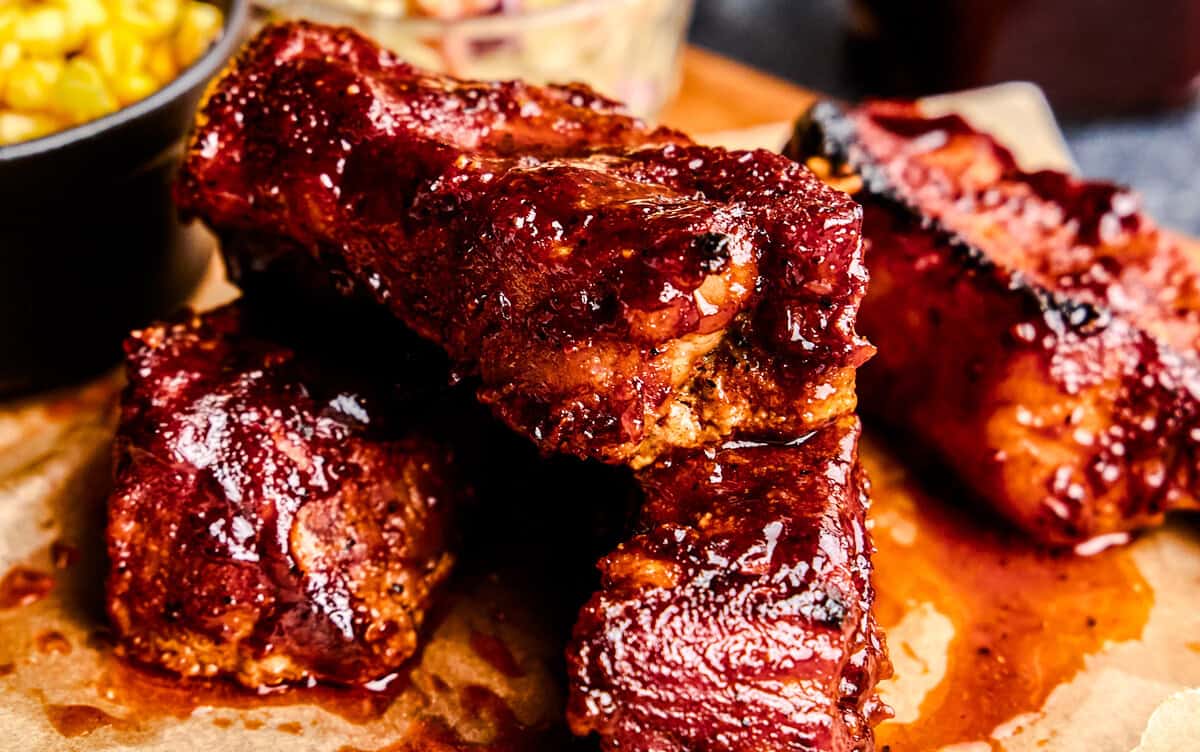 Country Style Pork Ribs stacked on parchment paper.