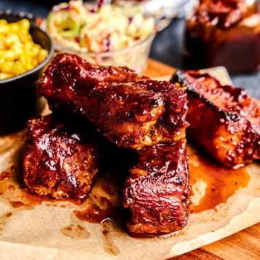 Country Style Pork Ribs stacked on parchment paper.