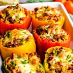 A baking dish full of Easy Stuffed Bell Peppers topped with melted cheese.