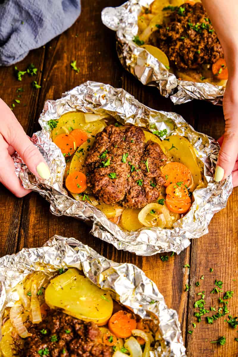 Hands opening a Hobo Foil Packets.