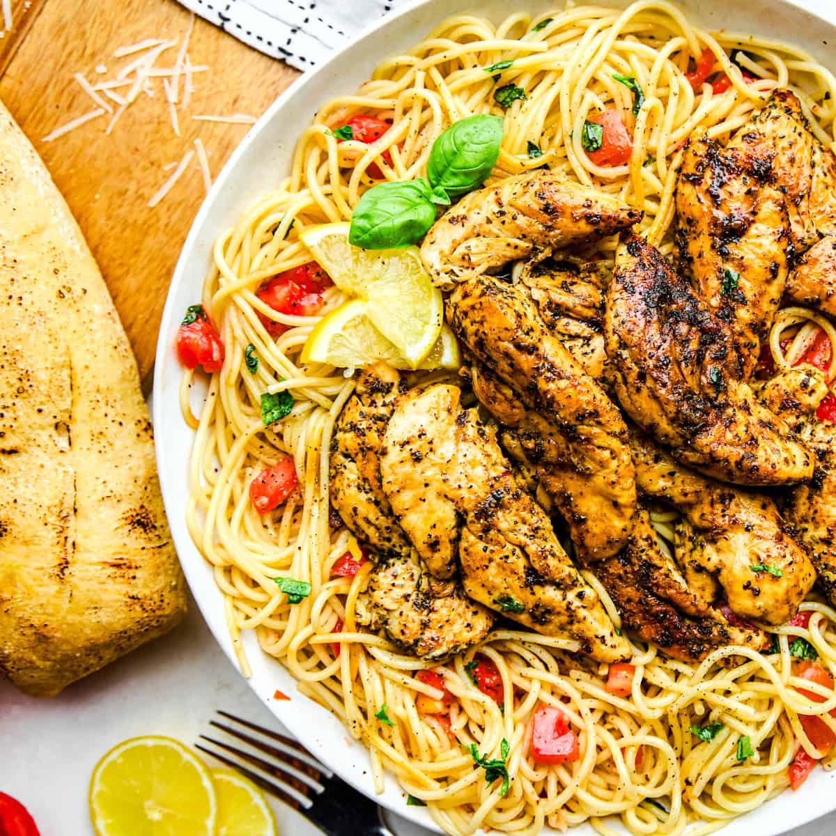 Lemon Herb Chicken Spaghetti with tomatoes and basil.