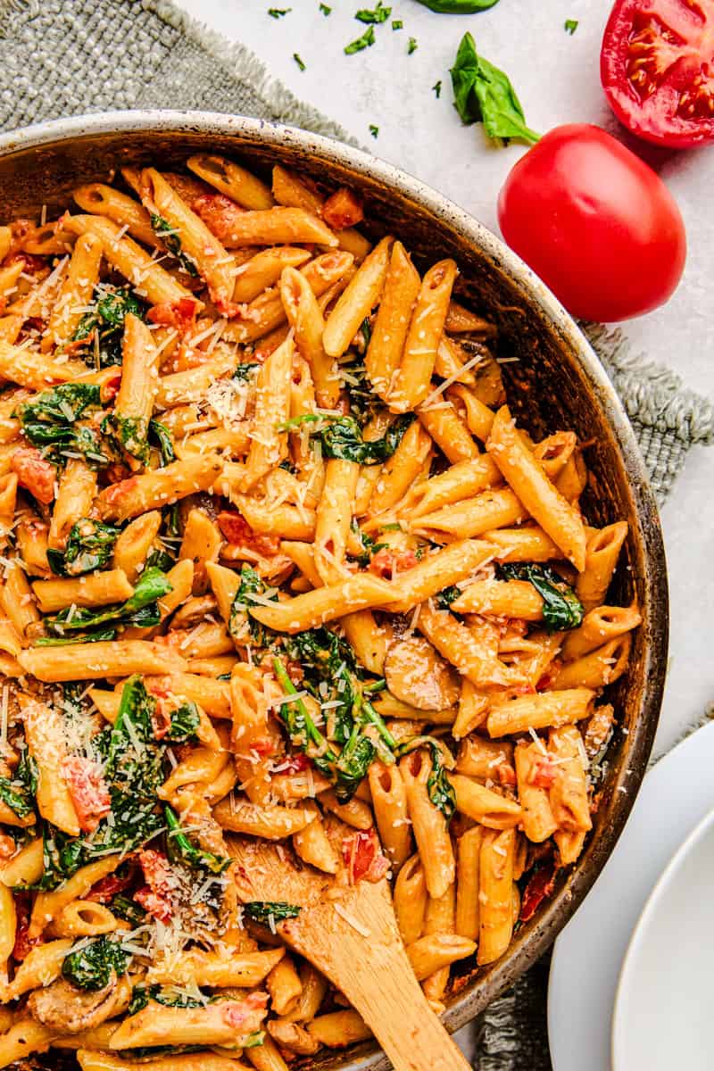 Penne Rosa in a pan sprinkled with parmesan cheese.