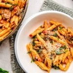 A bowl of Penne Rosa sprinkled with parmesan cheese.