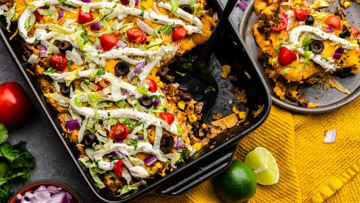 Overhead shot of Taco Casserole with scoop taken out and placed on a plate.