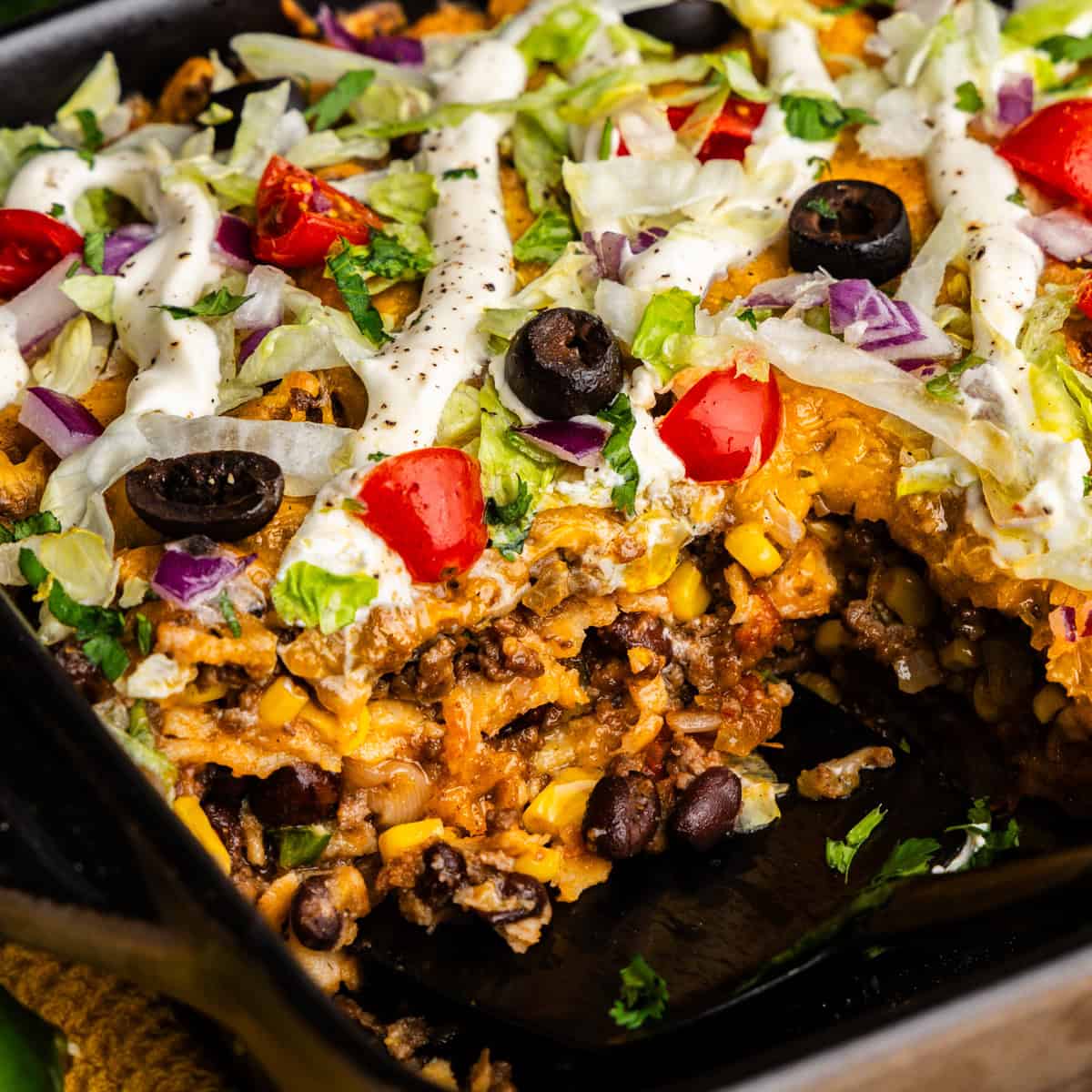 Closeup of Taco Casserole with a scoop taken out.