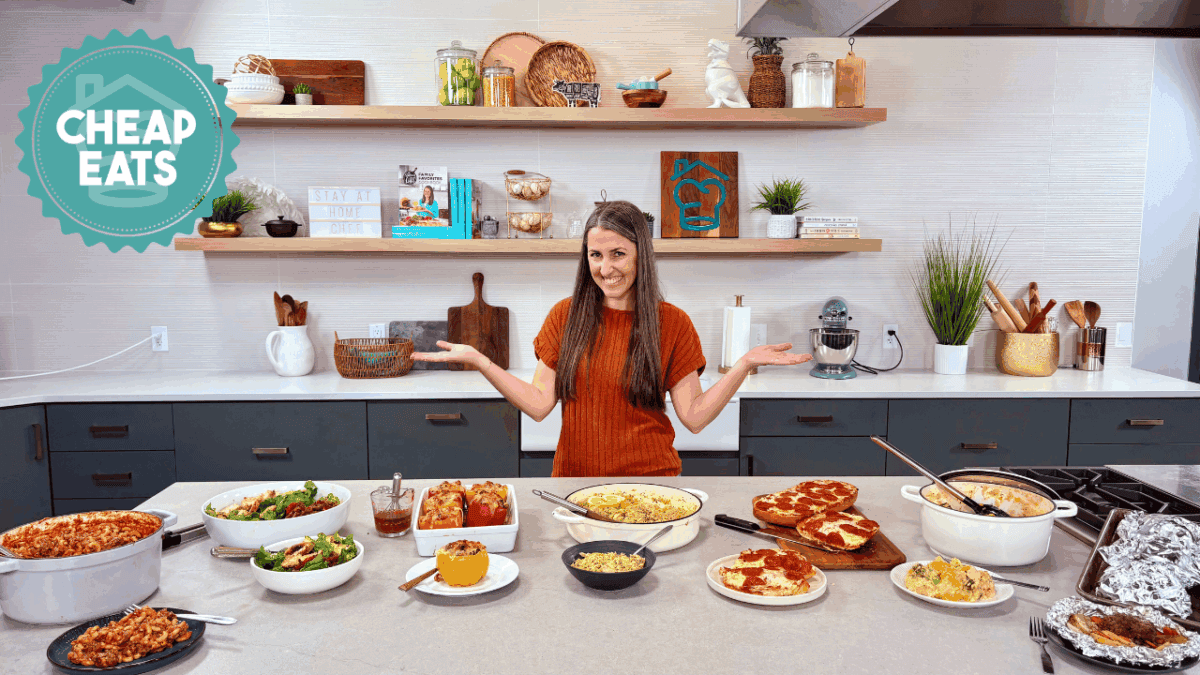 A photo of Rachel in The Stay At Home Chef Kitchen with the meals from Week 1 of the Cheap Eats Meal plan on display on the kitchen counter.