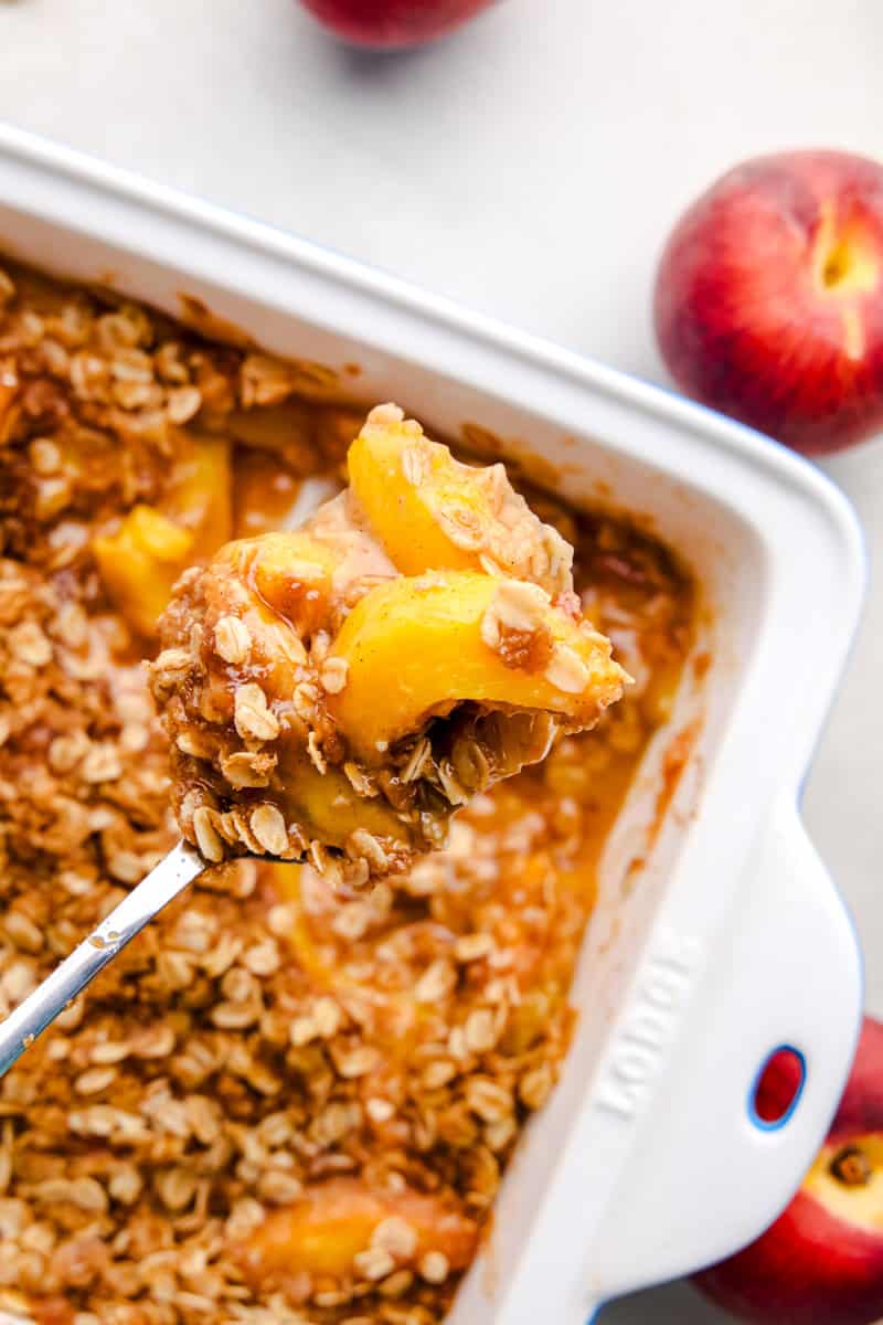 An overhead image of a spoonful of Best Ever Peach Crisp.