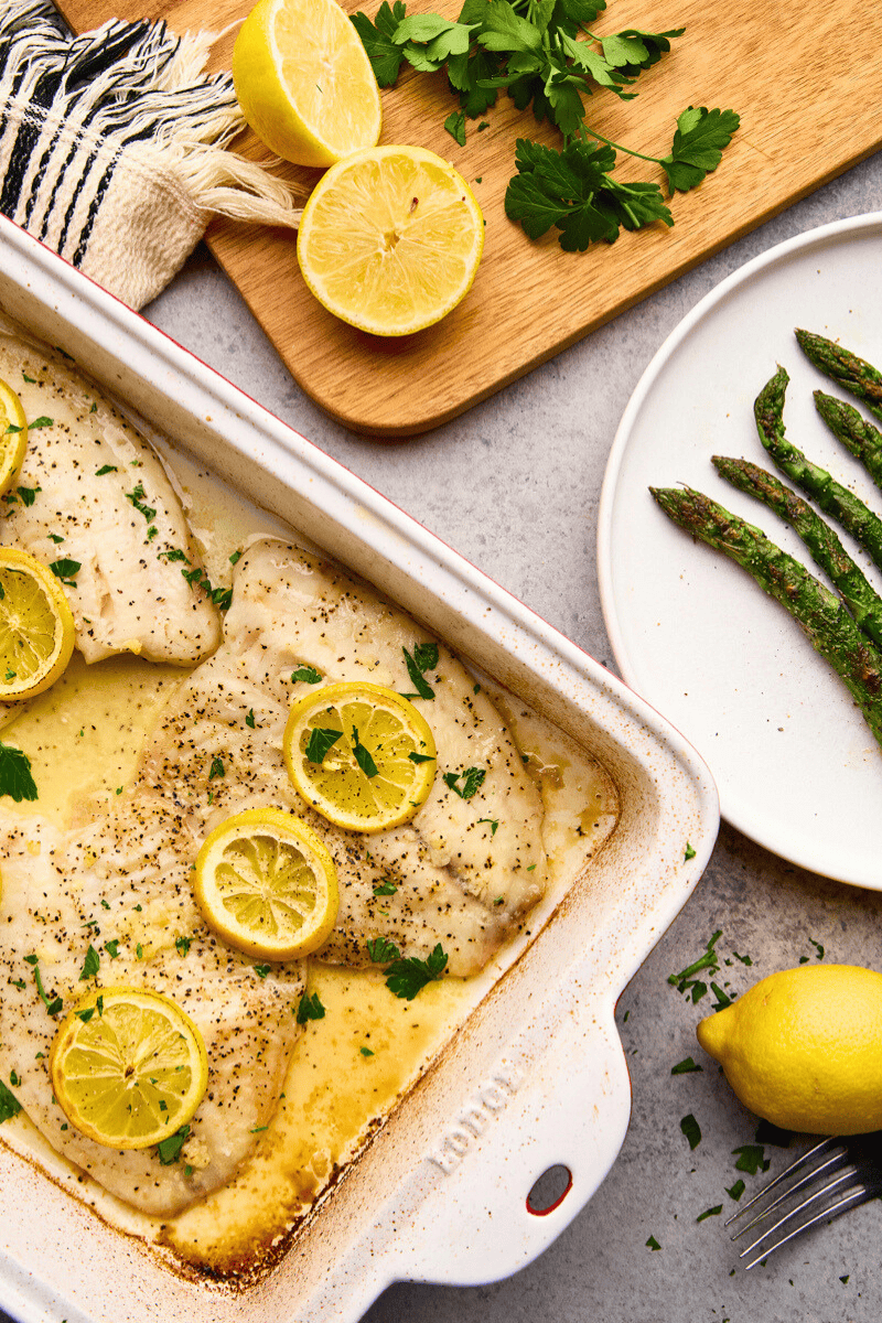 An overhead view of a pan of lemon garlic baked tilapia ready to serve.