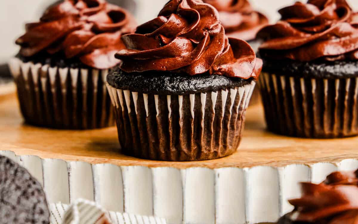 A tray of The Most Amazing Chocolate Cupcakes topped with rich chocolate frosting.