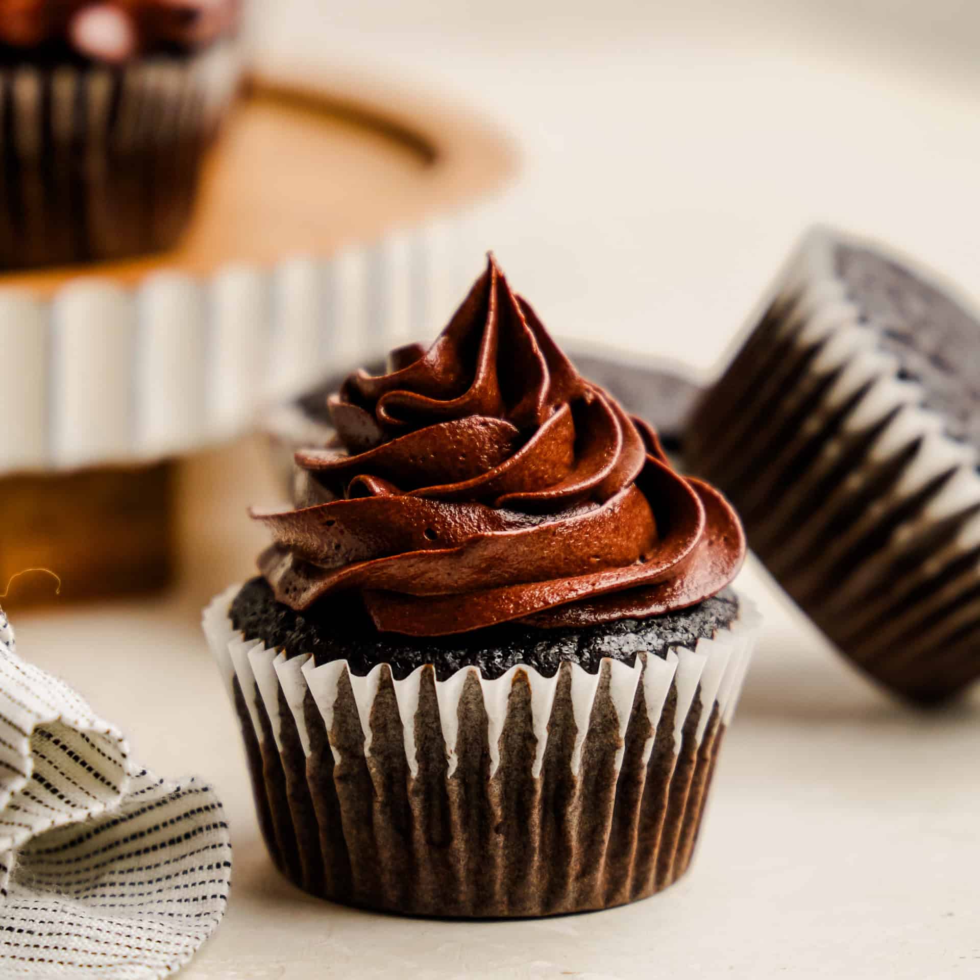 A closeup image of the Most Amazing Chocolate Cupcake topped with rich chocolate frosting.