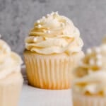 A Most Amazing White Cupcakes with crystal sugar and white sprinkles.