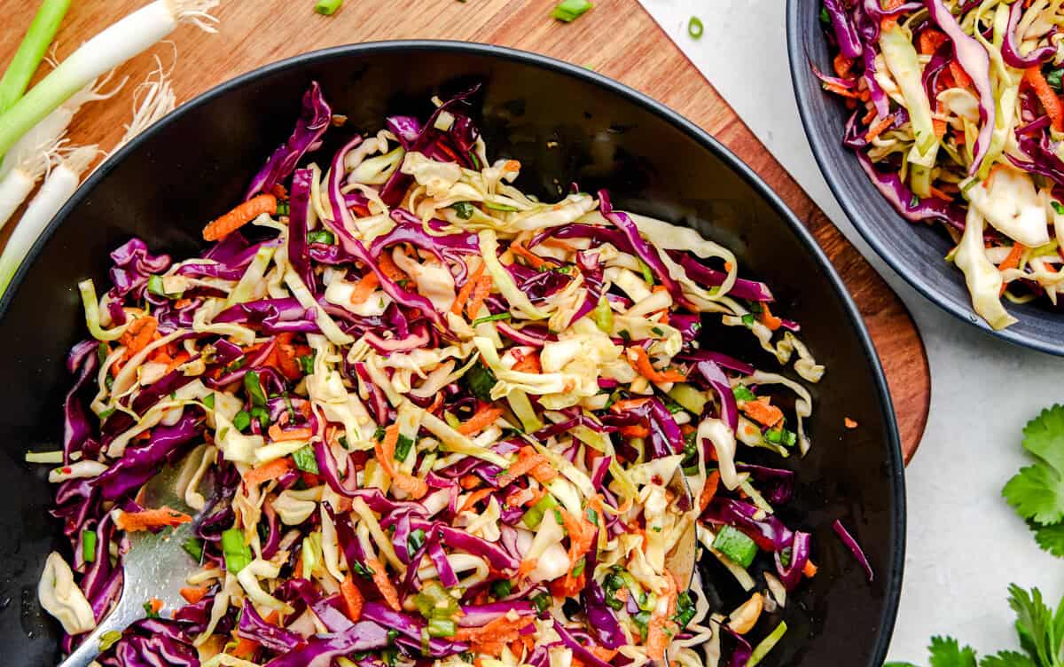 Spicy Sesame Coleslaw in a black serving bowl.